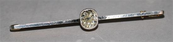 An early 20th century 15ct gold and platinum solitaire diamond bar brooch, 2in.